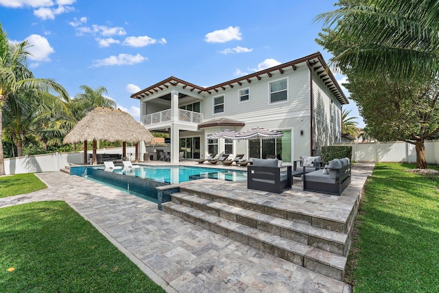 rear view of house featuring a patio, a fenced backyard, a gazebo, a yard, and outdoor lounge area