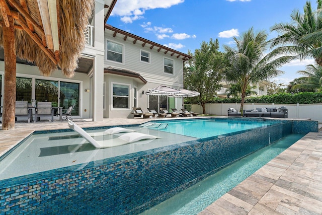 view of swimming pool featuring an outdoor living space, a patio area, and a fenced backyard