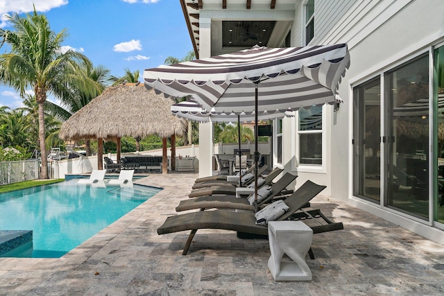 view of swimming pool with fence, a gazebo, outdoor dining area, a fenced in pool, and a patio area