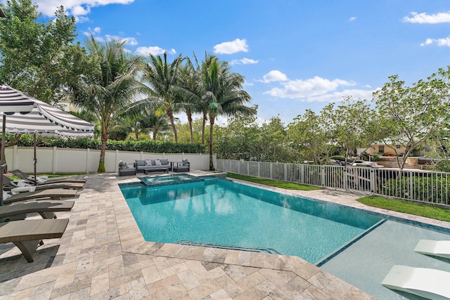 view of swimming pool featuring a fenced backyard, an outdoor living space, a pool with connected hot tub, and a patio