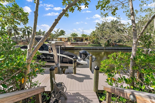 dock area with boat lift and a water view