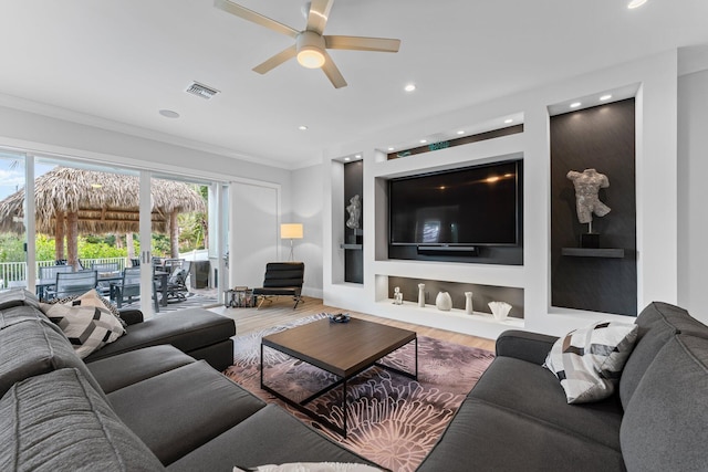 living area featuring visible vents, built in features, ornamental molding, recessed lighting, and wood finished floors