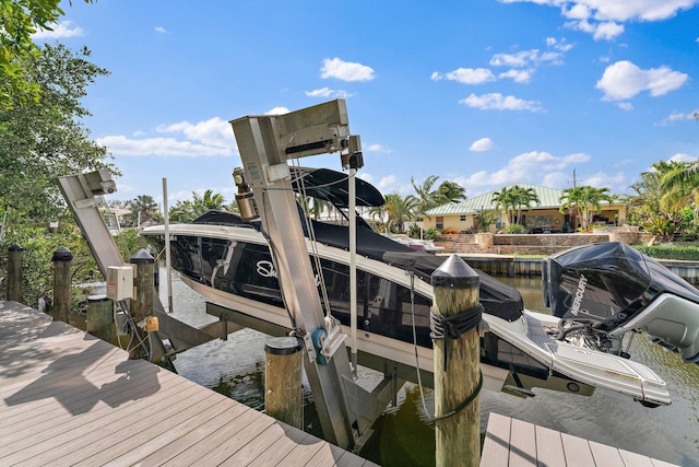 view of dock featuring boat lift and a water view