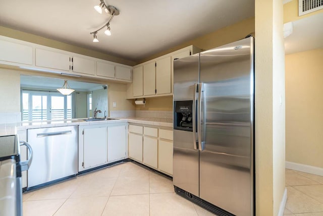 kitchen with white cabinetry, visible vents, stainless steel appliances, and light countertops