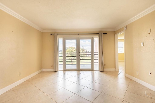 unfurnished room with light tile patterned flooring, baseboards, ornamental molding, and french doors