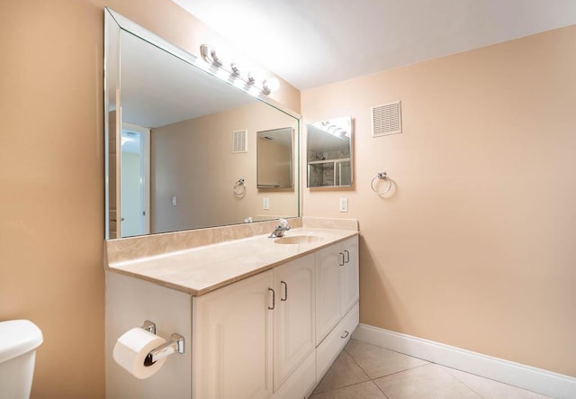 bathroom with toilet, tile patterned flooring, visible vents, and baseboards