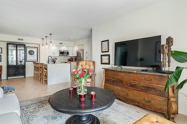 living room with light tile patterned flooring and visible vents