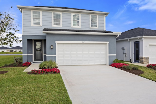 traditional-style house with driveway, a front lawn, an attached garage, and stucco siding