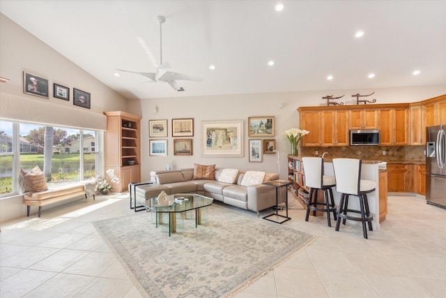 living area featuring vaulted ceiling, light tile patterned flooring, and recessed lighting