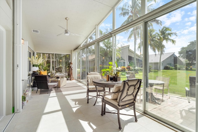 sunroom / solarium featuring a ceiling fan, lofted ceiling, and visible vents