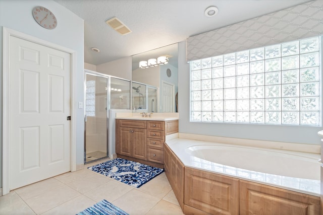 full bath with a textured ceiling, visible vents, vanity, tile patterned floors, and a stall shower