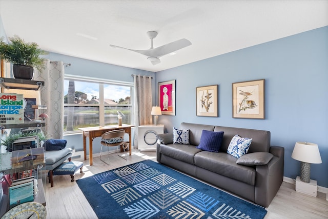 living area with ceiling fan, wood finished floors, and baseboards