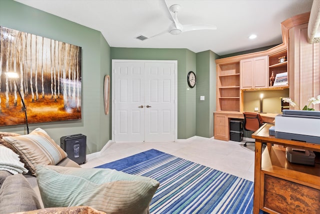 bedroom with light tile patterned floors, visible vents, baseboards, a closet, and built in study area