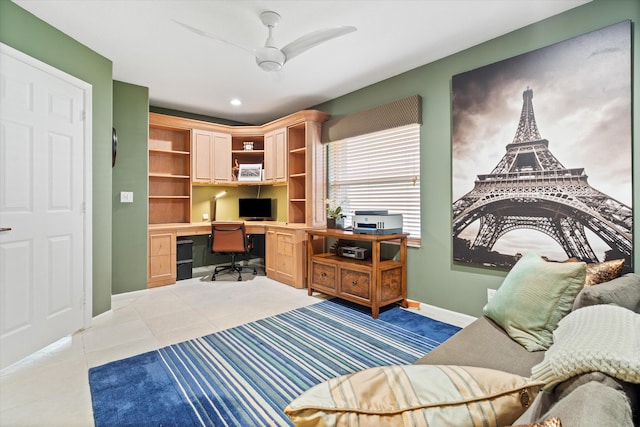 office area featuring light tile patterned floors, ceiling fan, built in desk, and baseboards