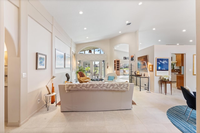 living room with high vaulted ceiling, visible vents, light tile patterned flooring, and recessed lighting