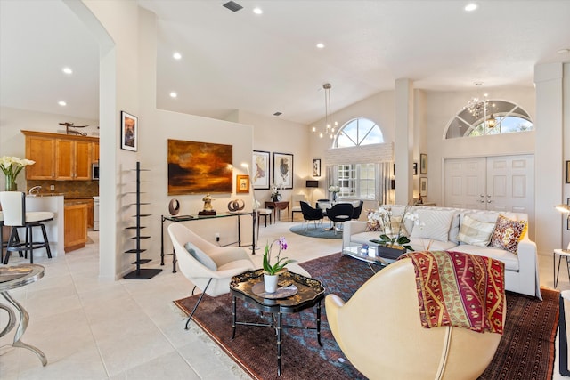 living room featuring a chandelier, high vaulted ceiling, light tile patterned floors, and recessed lighting