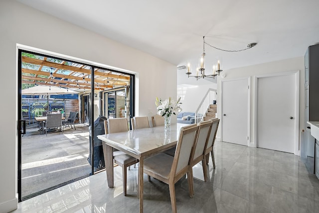 dining area featuring a chandelier and stairway