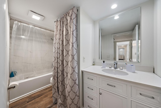 bathroom featuring shower / tub combo, vanity, recessed lighting, and wood finished floors