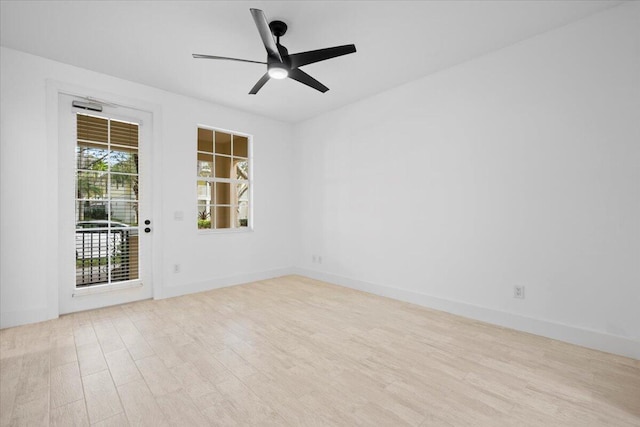 spare room with ceiling fan, wood finished floors, and baseboards