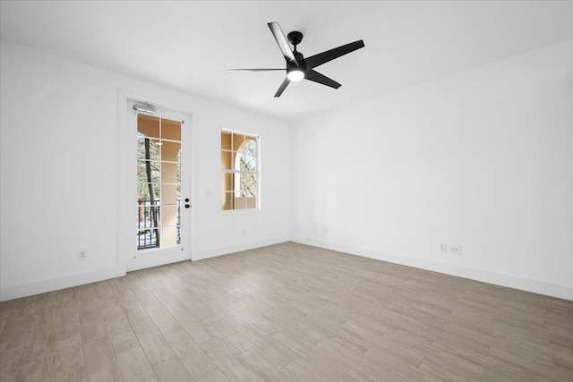 spare room with a ceiling fan, baseboards, and wood finished floors