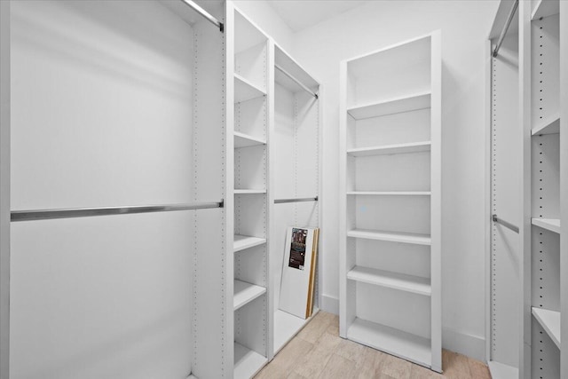 walk in closet featuring wood finished floors