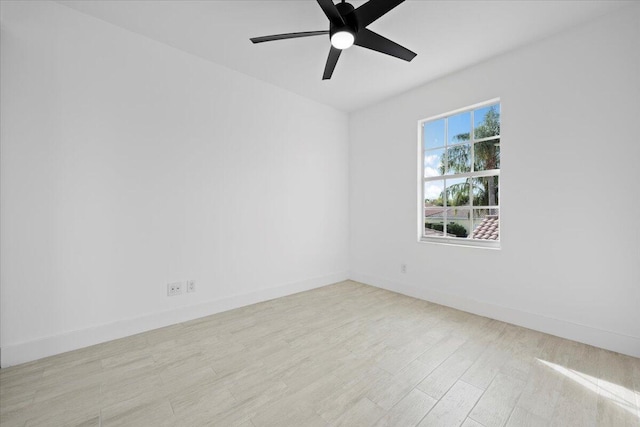 spare room with ceiling fan, wood finished floors, and baseboards