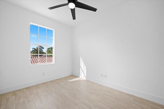 empty room with a ceiling fan, baseboards, and wood finished floors