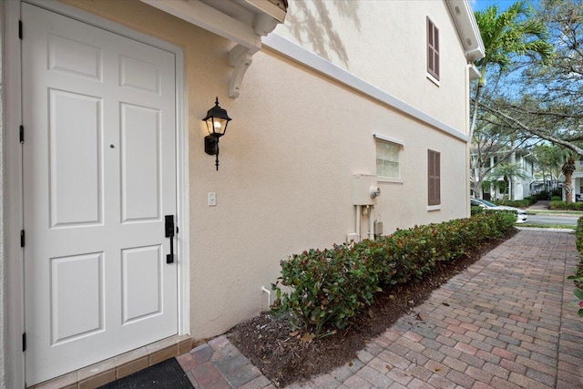 doorway to property with stucco siding