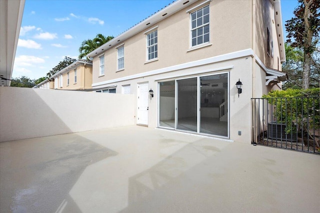 back of property featuring a patio, fence, and stucco siding