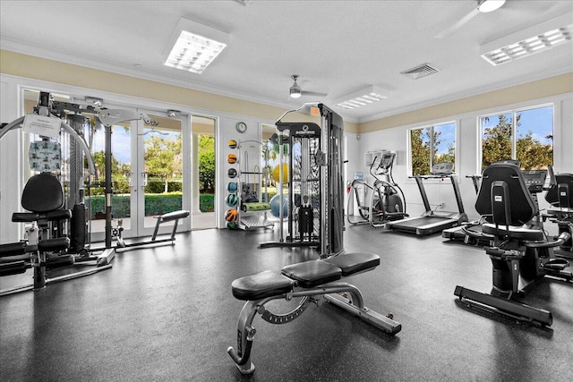 exercise room with a ceiling fan, visible vents, and crown molding