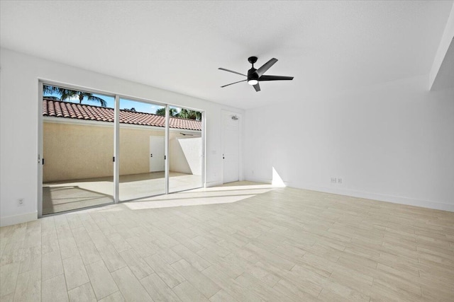 unfurnished bedroom with a ceiling fan, baseboards, and wood finished floors