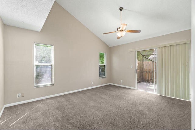 carpeted spare room featuring a wealth of natural light, ceiling fan, and baseboards