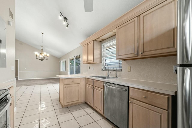 kitchen with light countertops, stainless steel appliances, a sink, and light brown cabinetry