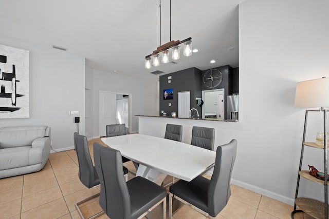 dining space with baseboards, visible vents, and light tile patterned flooring