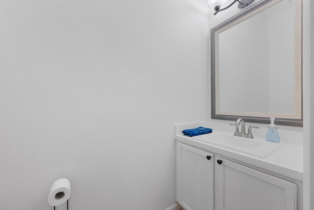 bathroom featuring baseboards and vanity