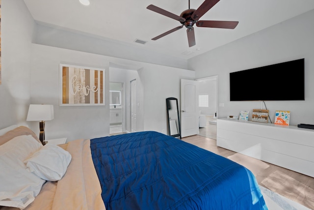 bedroom with ceiling fan, wood finished floors, connected bathroom, and visible vents