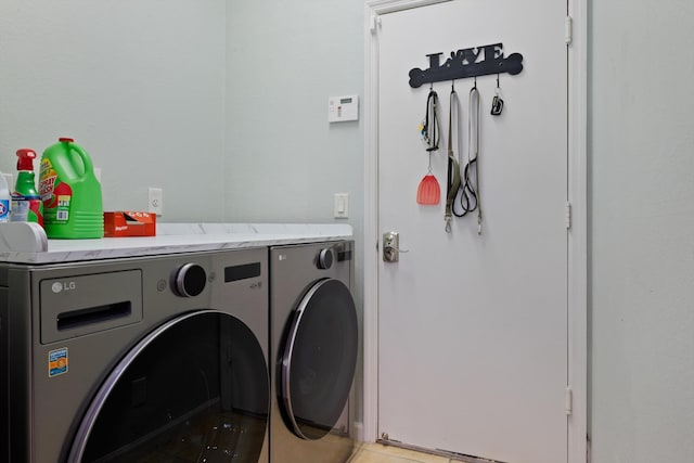 washroom with washing machine and dryer and laundry area