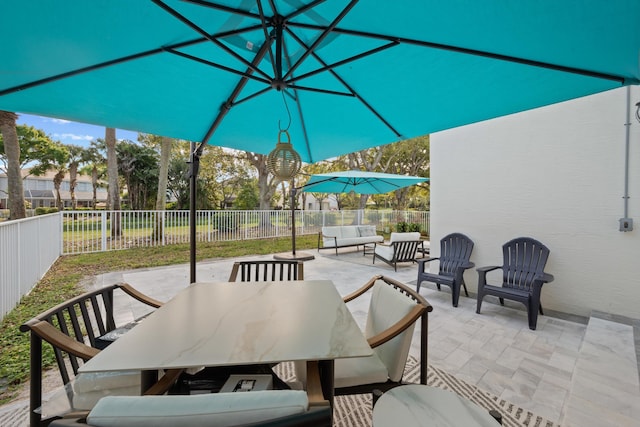 view of patio with outdoor dining area, outdoor lounge area, and a fenced backyard