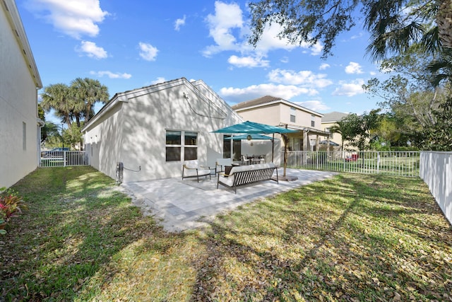 back of house featuring a fenced backyard, an outdoor living space, a lawn, and a patio