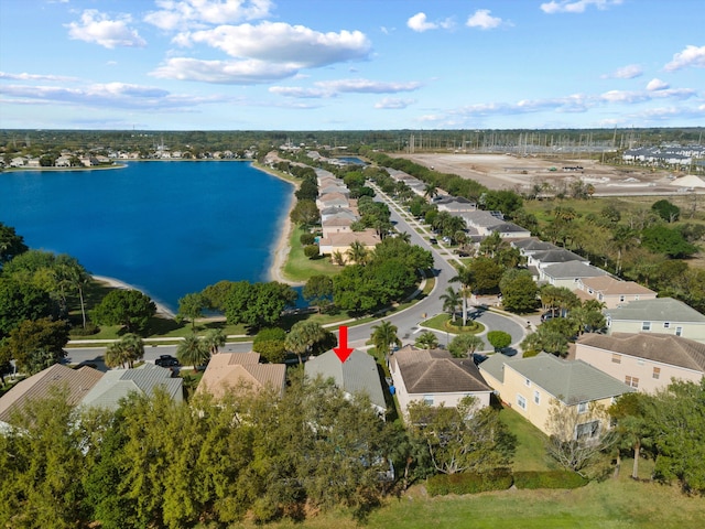 drone / aerial view featuring a residential view and a water view