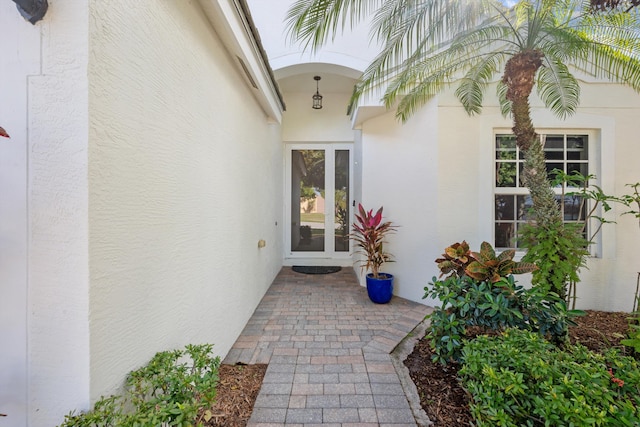 property entrance with stucco siding