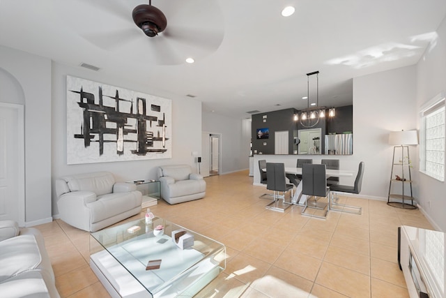 living room with light tile patterned floors, baseboards, visible vents, and recessed lighting