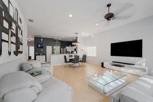 living room with light tile patterned floors, baseboards, visible vents, and recessed lighting