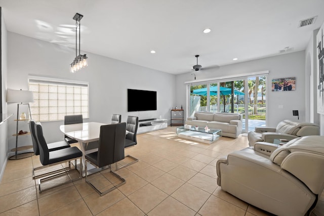 living area featuring light tile patterned floors, visible vents, a ceiling fan, and recessed lighting