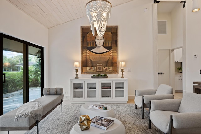 living area with wood ceiling, high vaulted ceiling, and visible vents