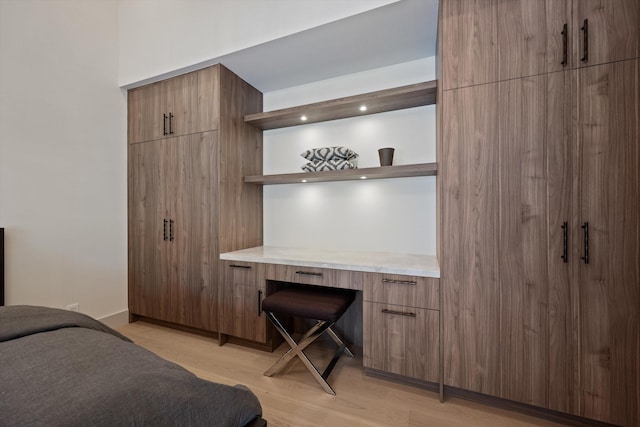 bedroom featuring light wood-type flooring and baseboards