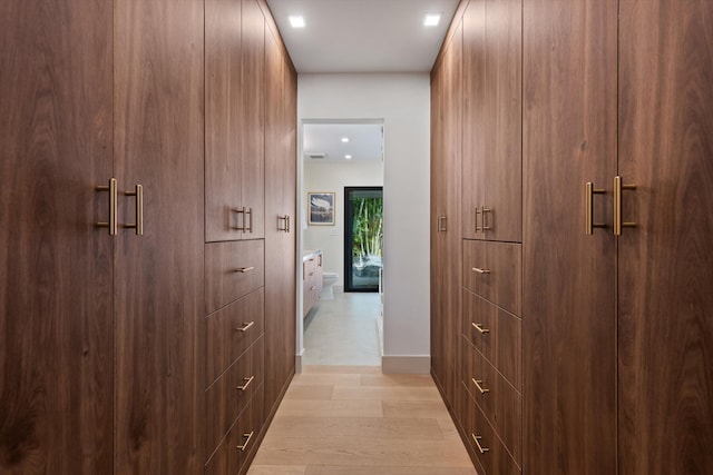 hall featuring visible vents and light wood-style flooring