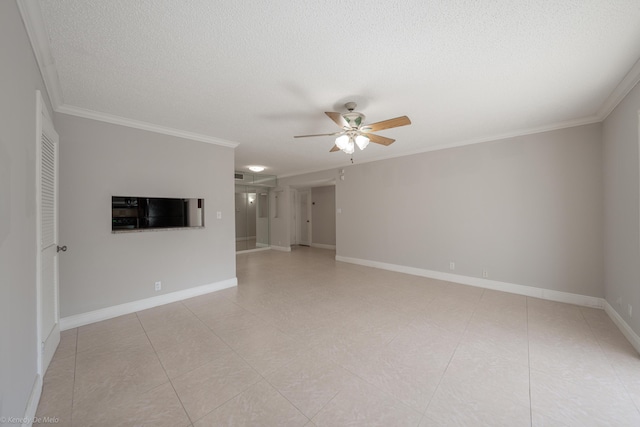 spare room with a ceiling fan, ornamental molding, a textured ceiling, and baseboards