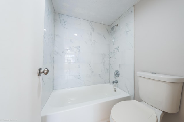 full bathroom featuring a textured ceiling, shower / bath combination, and toilet