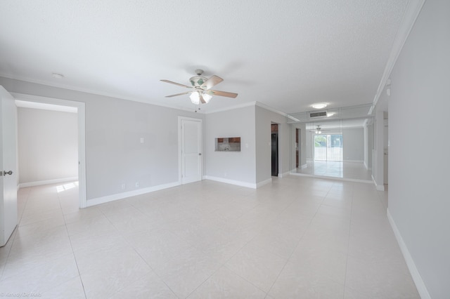 unfurnished room featuring a textured ceiling, ceiling fan, baseboards, and crown molding